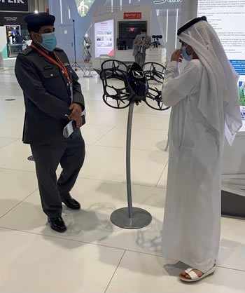 Delegates discussing the RAPTOR Hunter Killer drone at IDEX 2021